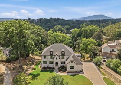 Aerial view of a Cuthbertson Homes custom home on a wooded lot