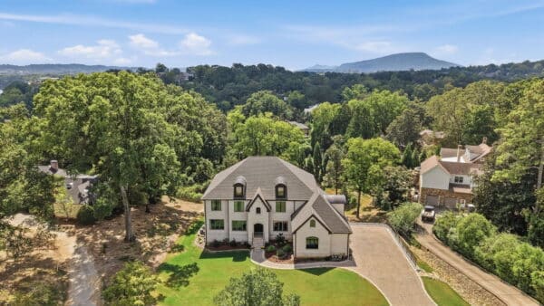 Aerial view of a Cuthbertson Homes custom home on a wooded lot
